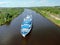 Aerial view journey by passenger ship along the river. Panoramic landscape from a height ship sails along a large river