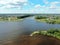 Aerial view journey by passenger ship along the river. Panoramic landscape from a height ship sails along a large river