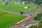 Aerial view of a Ju-Guang Express Train traveling on a railway curve thru green rice paddy fields