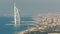 Aerial View of Jumeirah Beach and Dubai skyline with Burj Al Arab at evening timelapse, UAE