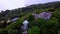 Aerial view of jungle and pool villa in Thailand at sunset. Drone shot flying around the jungle villa with a swimming