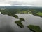 Aerial view karst lake in Novgorod oblast. Nice nature with village shore Summer