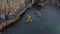 Aerial view of kayaks floating on water surrounded by rocks