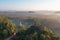 Aerial view of Khao Na Nai pagoda stupa. Luang Dharma Temple Park with green mountain hills and forest trees, Surat Thani,