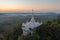 Aerial view of Khao Na Nai pagoda stupa. Luang Dharma Temple Park with green mountain hills and forest trees, Surat Thani,