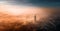 Aerial view of Kiev Pechersk Lavra at dawn and the city covered with thick fog in the background.