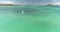 Aerial view of kite surfer, slow motion, white kite and hydrofoil