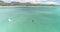 Aerial view of kite surfer, slow motion, white kite and hydrofoil