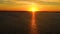 Aerial view  Kitesurfers swim at high speed in the open sea at sunset. Drone shot at three athletes on boards floating above the