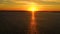 Aerial view  Kitesurfers swim at high speed in the open sea at sunset. Drone shot at three athletes on boards floating above the