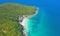 Aerial view of Koh Larn beach, Pattaya with blue turquoise seawater, mountain hills, and tropical green forest trees with Andaman