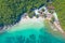 Aerial view of Koh Larn beach, Pattaya with blue turquoise seawater, mountain hills, and tropical green forest trees with Andaman