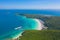 Aerial view of Koh Larn beach, Pattaya with blue turquoise seawater, mountain hills, and tropical green forest trees with Andaman