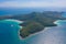 Aerial view of Koh Larn beach, Pattaya with blue turquoise seawater, mountain hills, and tropical green forest trees with Andaman