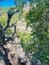 Aerial view lacy appearance of travertine cliffs with Arbuckle Mountain at Bridal Veil Falls