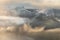 Aerial view of Lake District snowcapped mountains with lingering mist taken on a Winter morning. Catbells, Derwentwater, UK.