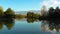 Aerial view. Lake at the edge of the mountains with forest reflected in the clear water. Idyllic autumn landscape.