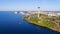 Aerial view from the lake. Observation tower and amusement park on the shore.