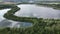 Aerial view of a lake separated by tree forest