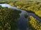 Aerial view of a lake surrounded by dense boreal aka taiga