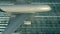 Aerial view of a landing airplane revealing flag of Saudi Arabia on the airfield of an airport. Air travel related