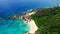 Aerial view (landscape) of empty tropical paradise beach (coast) with white sand and azure sea water