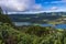 Aerial view of landscape with green and blue crater lakes of Lagoa Azul and Lagoa Verde and Sete Cidades village in the