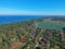 Aerial view at landscape with sea, field, forest and small village buildings.