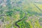 Aerial view landscape of winding small river among the small town railway station and bridge, stream in green field, top view