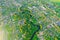 Aerial view landscape of winding small river among the small town, stream in green field