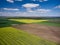 Aerial View of landscape with yellow rapeseed agricultural fields, springtime