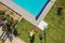 Aerial View of Landscaper Finishing Swimming Pool Side Landscape