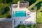 Aerial view of a large  backyard with a pool of a stone villa on a sunny day