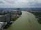 Aerial view of the large cargo ship on the Chao Phraya River with cityscape, The river with green water in rainy season.