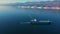 Aerial view of large cargo ship sailing in sea port at sunny day