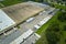 Aerial view of large commercial loading bay with many delivery trucks unloading and uploading retail goods for