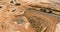 Aerial view of large construction site with several crawler excavator machines in moving earth it onto the dump truck