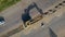 Aerial view of large crawler excavator digs ground between two lanes of motorway