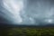 Aerial view of large dark rain clouds over a natural tropical forest area, created with Generative AI