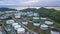 Aerial view of large fuel storage tanks at oil refinery industrial zone, White oil storage tanks farm.