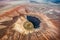 aerial view of a large meteor crater surrounded by scorched earth