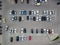 Aerial view of a large number of cars of different brands and colors standing in a parking