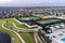 Aerial view of large tennis courts, swimming pool at community recreational center with mansions.