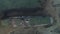 Aerial view of large vintage ship standing on the the pebbles surrounded by sea water against the mountain hills and