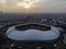 Aerial View of The largest stadium of Bekasi from drone when sunset and noise cloud. Bekasi, Indonesia, March 21, 2021