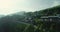 Aerial view of lateral side of mountain. Group of white mountain cottage