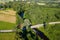 Aerial view of Latvian rural landscape with a winding river, forests and country roads at sunset