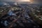 aerial view of lava flows with city in the background, resembling a twisted and burning maze