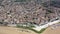 Aerial view of Libourne cityscape on banks of Dordogne river overlooking Gothic spire of Church of St. John Baptist