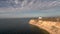 Aerial view of lighthouse on a cape in thessalonik Aggelohorii area, Greece, move forward by drone